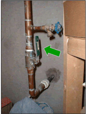 Photo of a water service line where it enters the home including the shut off valve